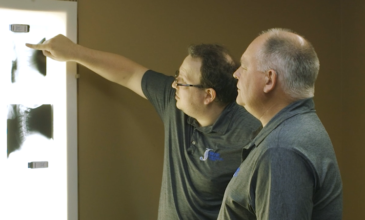 A doctor at Jorde Chiropractic reviewing a spinal x-ray