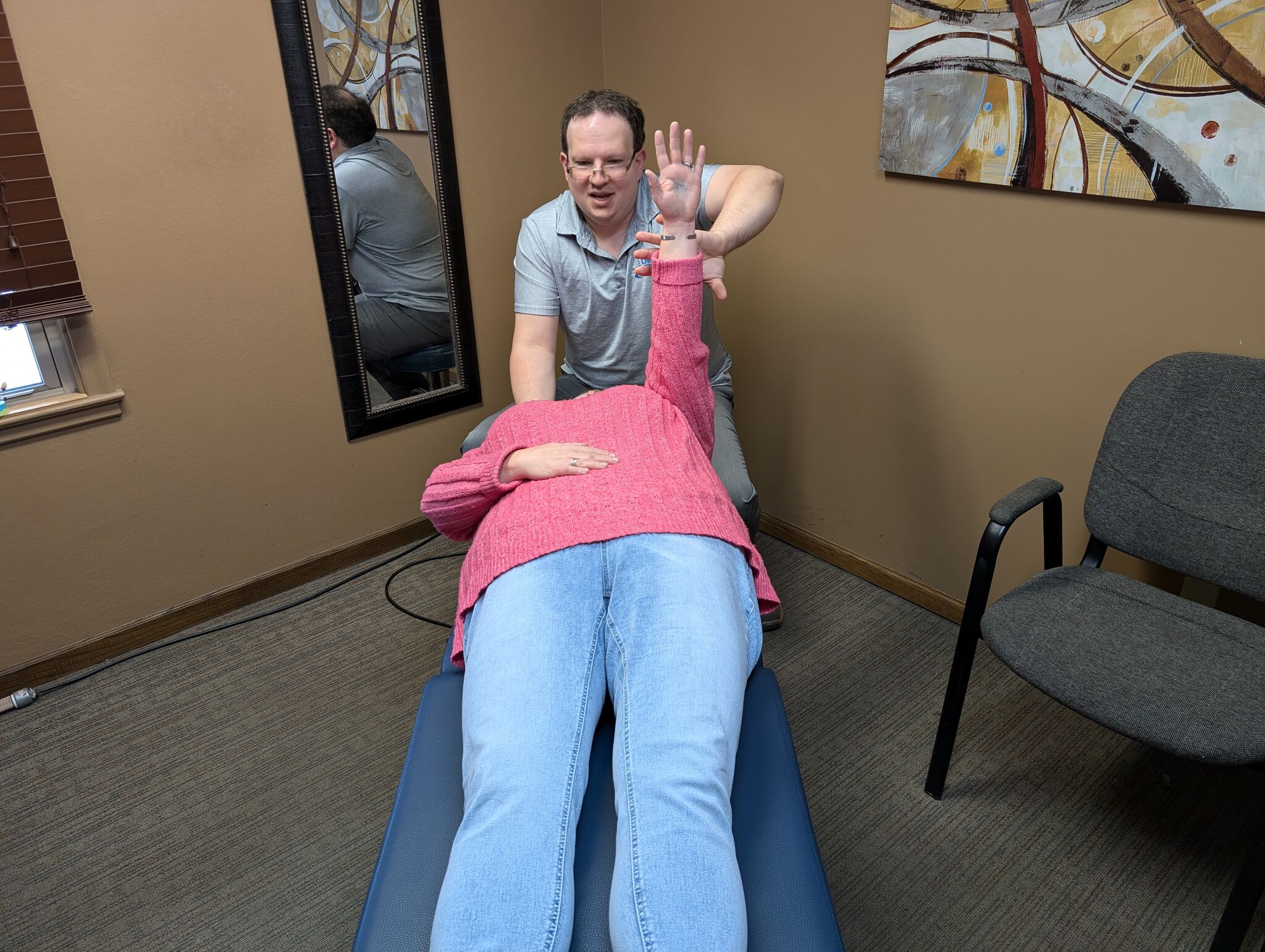A doctor at Jorde Chiropractic Clinic performing muscle testing on a patient